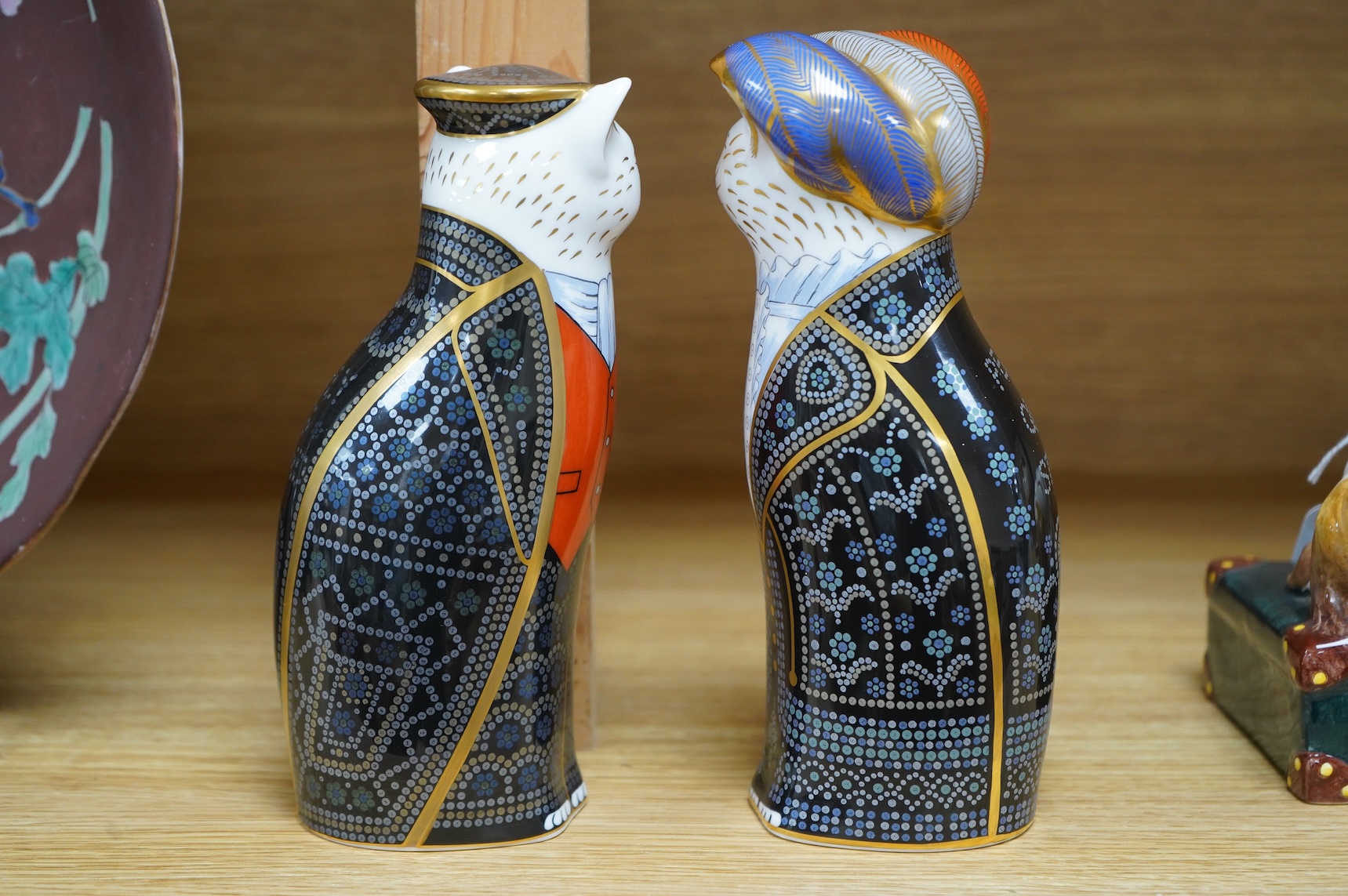 Two Royal Crown Derby cats compromising Pearly Queen and King, one with stopper, largest 20cm high